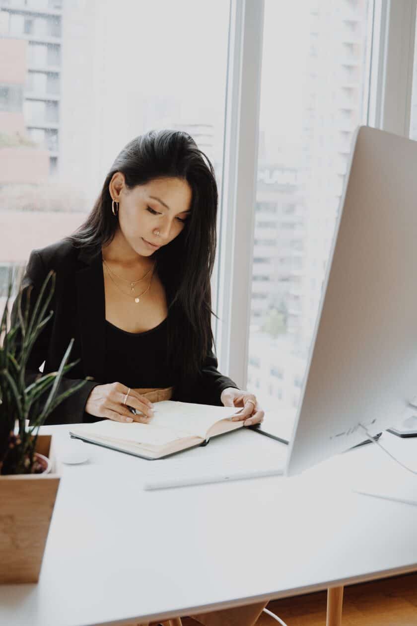 woman in black blazer sitting at the table